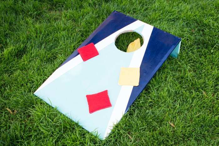DIY cornhole board on the grass with bean bags