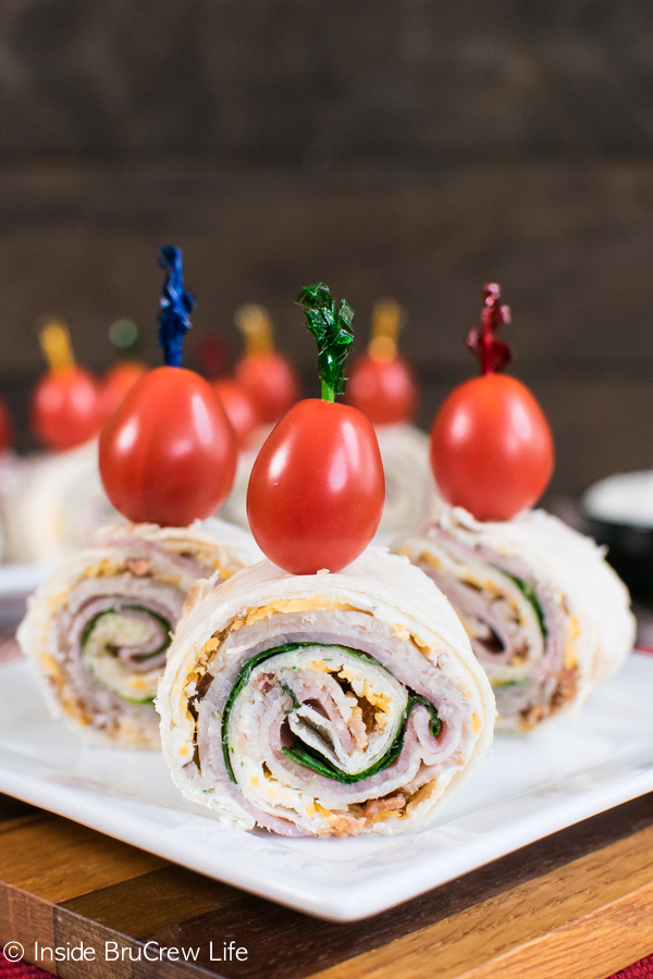 turkey club pinwheels with cherry tomatoes on top