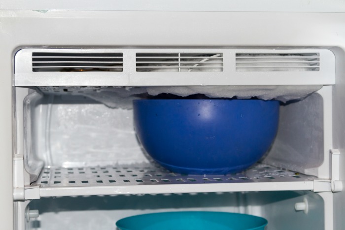 Use hot water to defrost a freezer