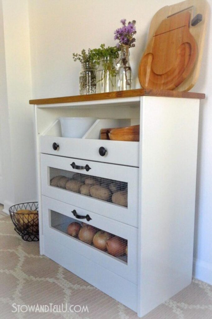 white vegetable bin with drawers and stained wood top