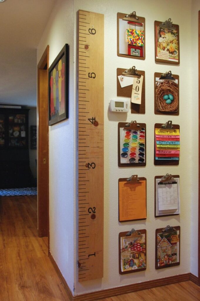 clipboards hanging on a wall, each holding artwork to display