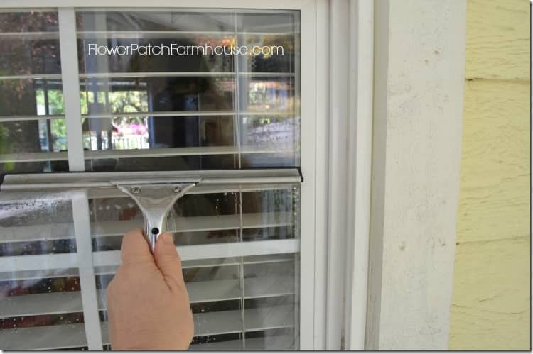 Cleaning a window with a squeegee