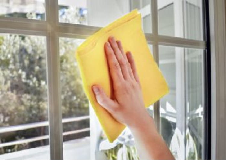 Wiping windows with a microfiber cloth