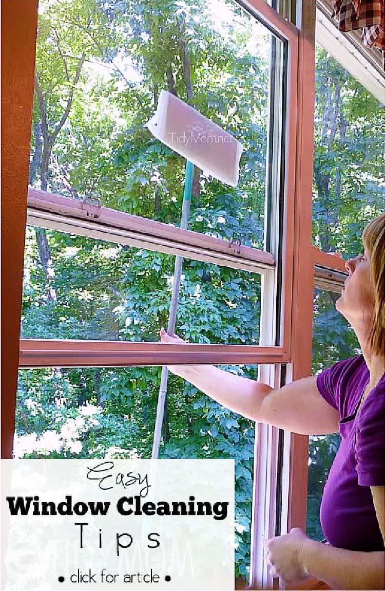 Woman cleaning the outside of their windows with a sponge mop wrapped in paper towels