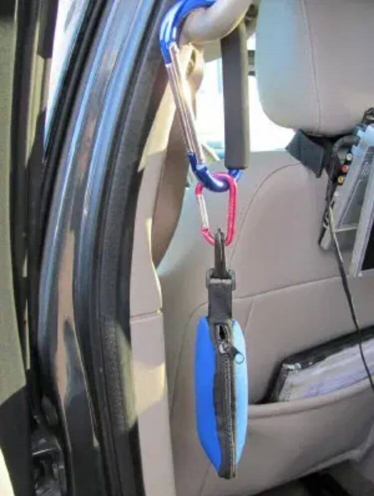 Car hack to keep kids stuff close - zippered pouch filled and hung up by a carabiner