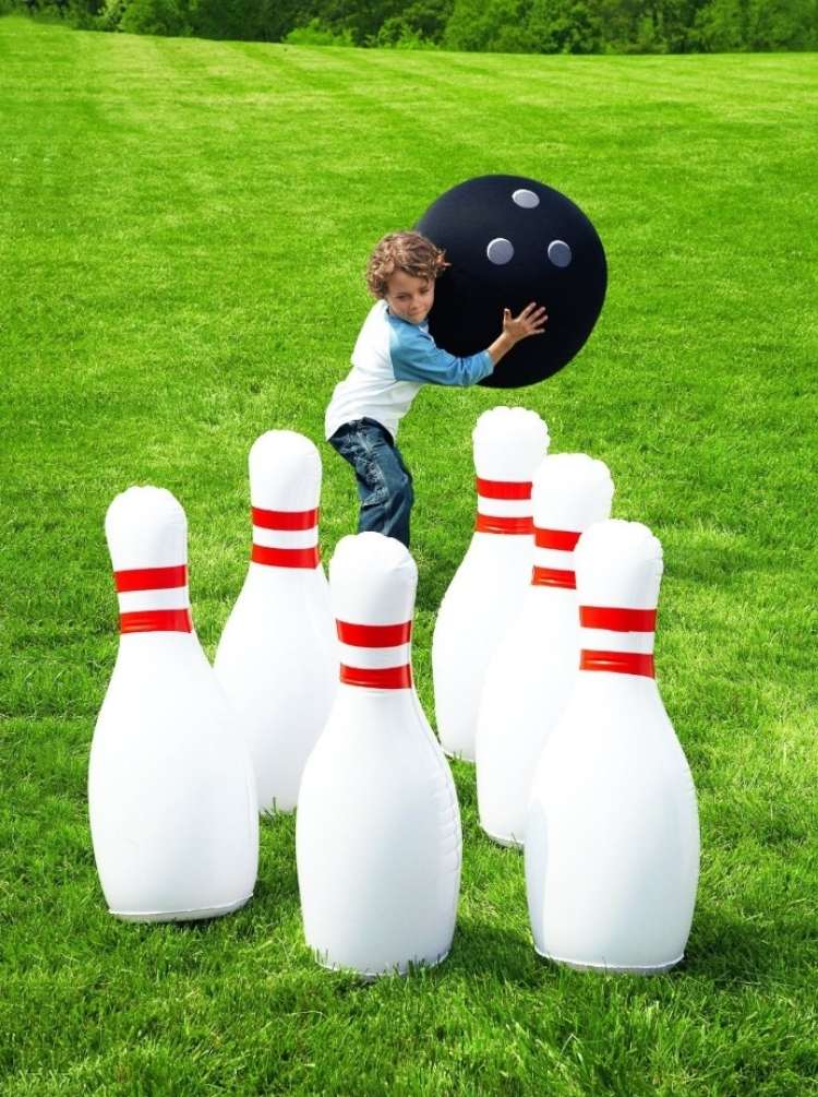 Backyard ideas: Child lawn bowling on green grass