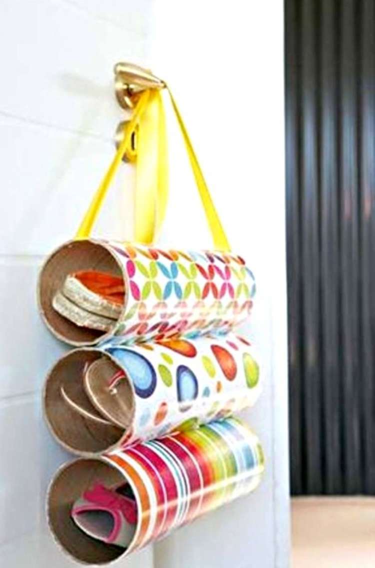 OneCrazyHouse Pringles Can Hacks Pringles cans wrapped in decorative paper, glued together and attached to wall with a ribbon holding shoes