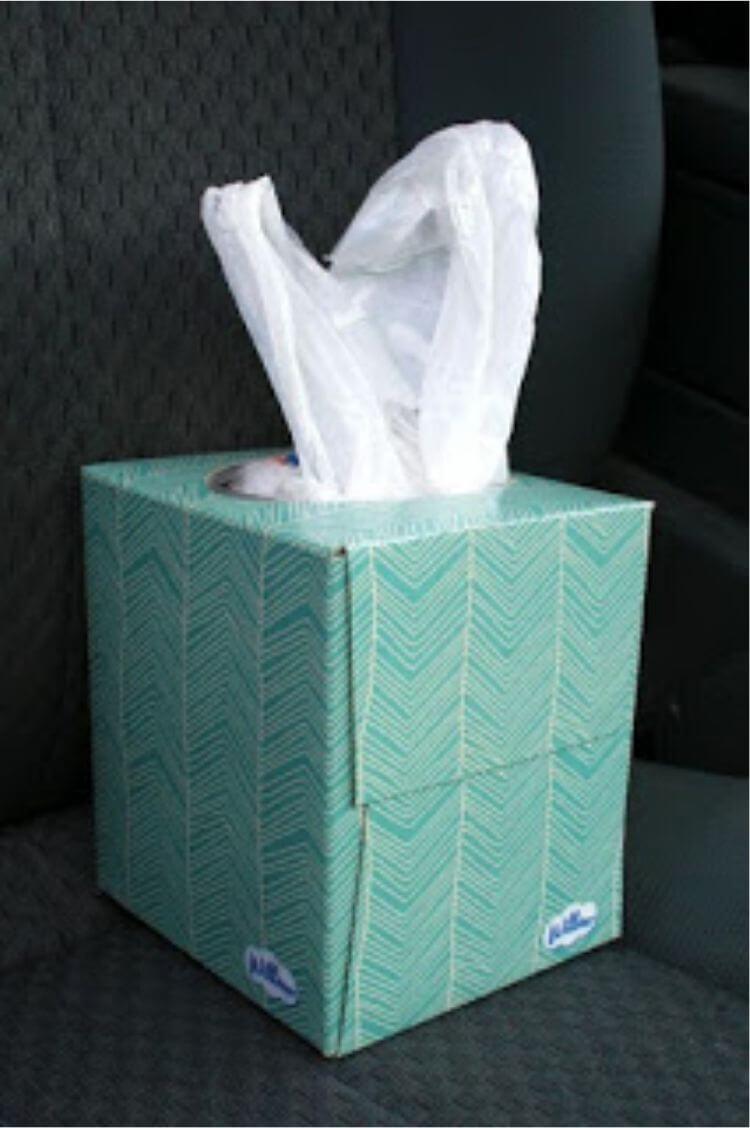 Tissue box filled with plastic sacks for an easy car storage hack