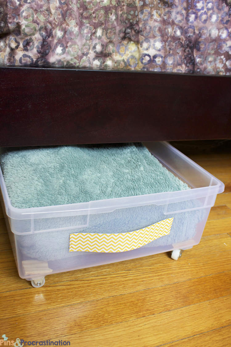 Plastic under-bed storage drawer used to make the most of wasted storage space.