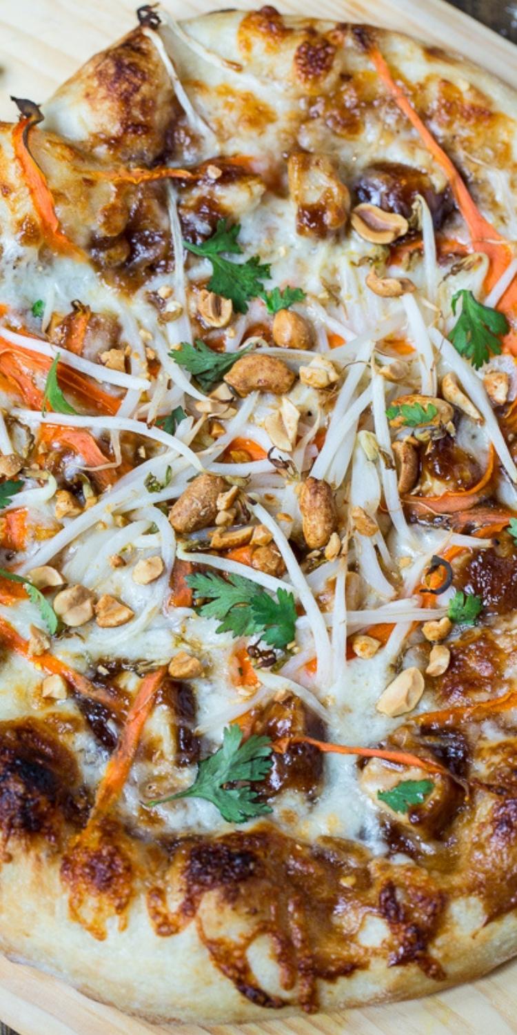 Sweet & Spicy Pad Thai Pizza topping recipe on yummy flatbread pizza. Peanuts, carrots, and chicken on cheese with pad thai sauce on medium thick crest. 