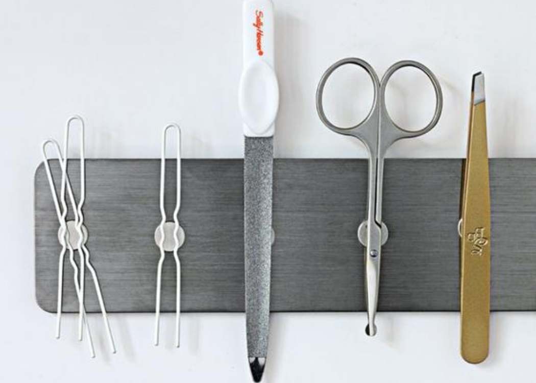 magnetic strip holding bobby pins, nail file, and scissors