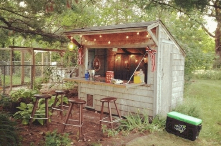 Cute and customized little tiki bar with drop down bar window and hanging lights