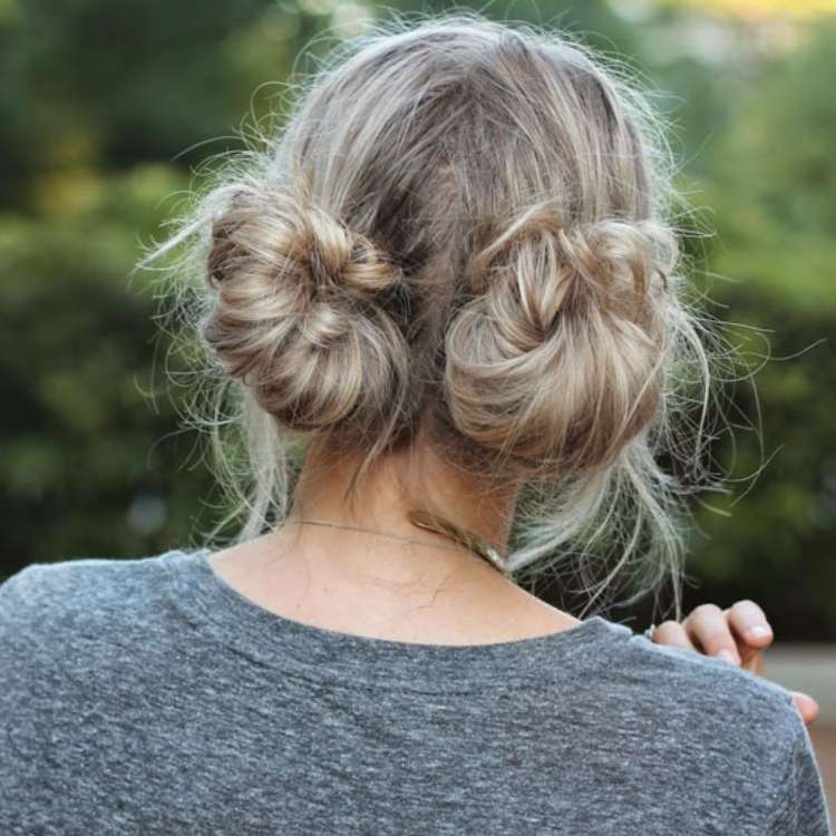  blonde woman with two braided pigtail bun in the back
