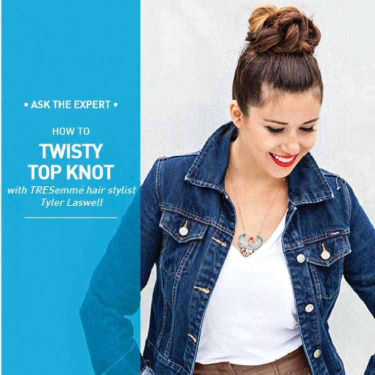 woman in a blue jean jacked wearing her hair on top of her head