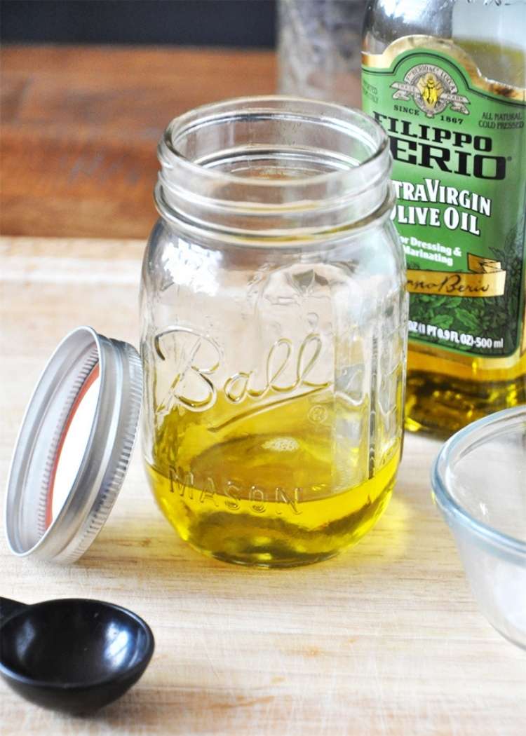 oil in an open jar on top of a tableas one of the tips for dry skin 