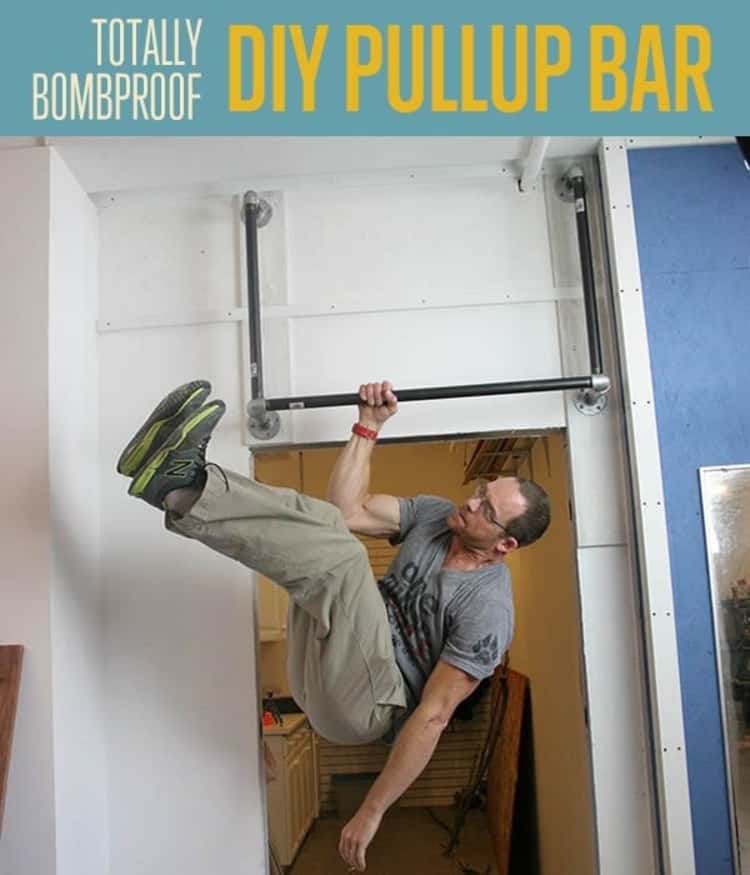 person hanging with one hand on a DIY pull-up bar 