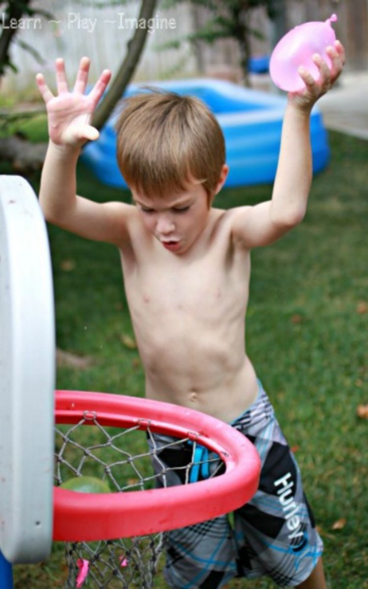 Boy playing Basketball with water balloons 