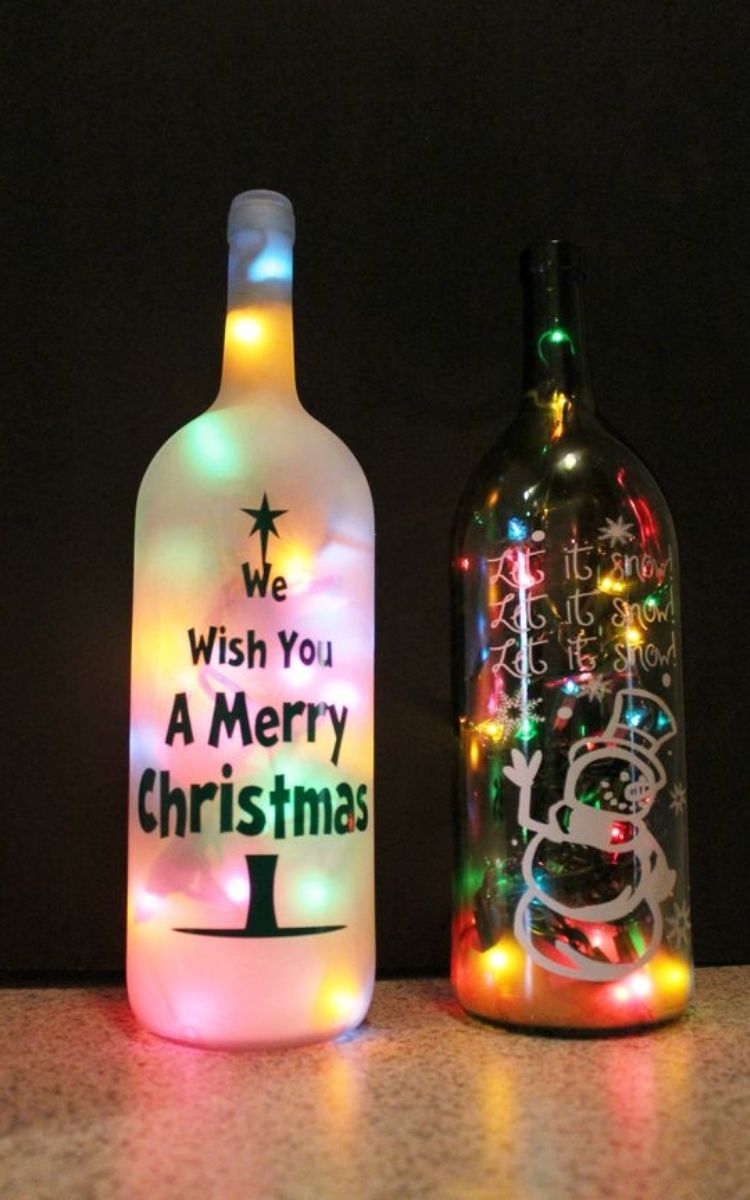 lighted wine bottles with painted Merry Christmas