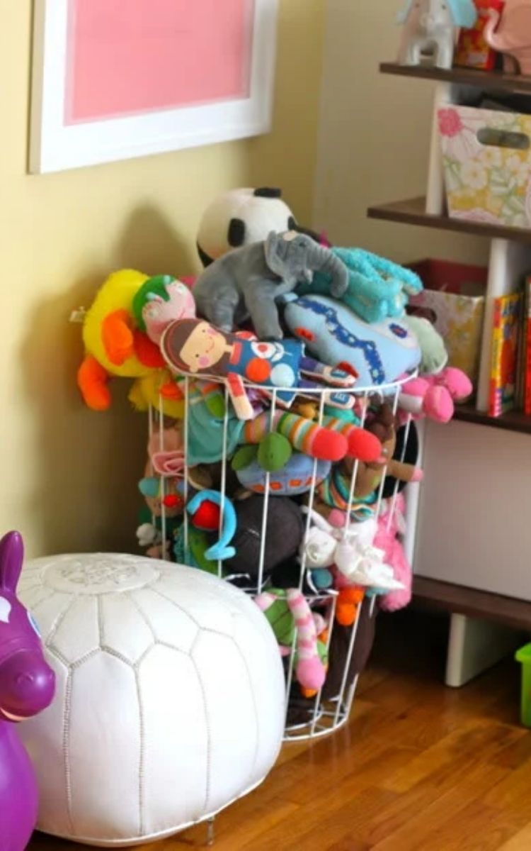 wire hamper with a pile of stuffed animals