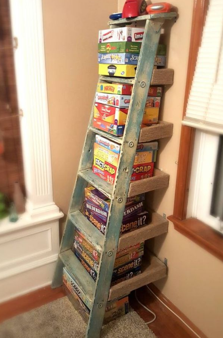 Old ladder turned into a storage shelf to hold all of your board games