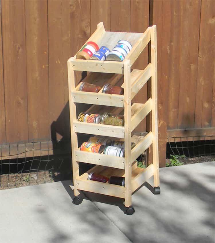 diy rotating wood canned food rack with canned goods inside sitting on driveway