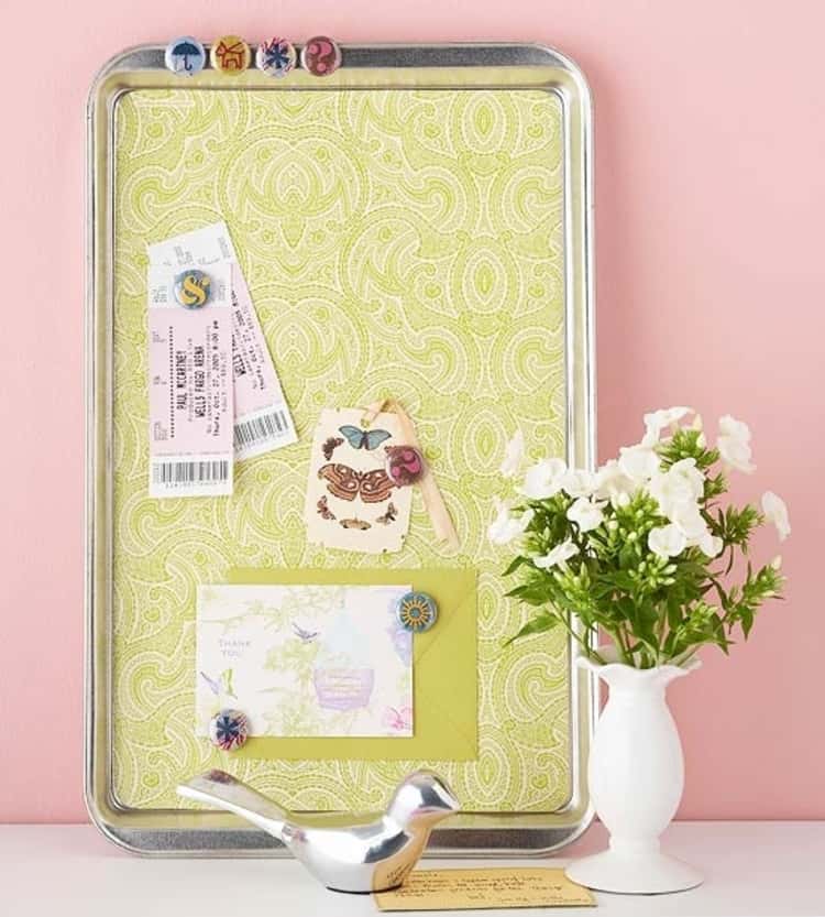 A cookie sheet accessorized and used as a bulletin board 