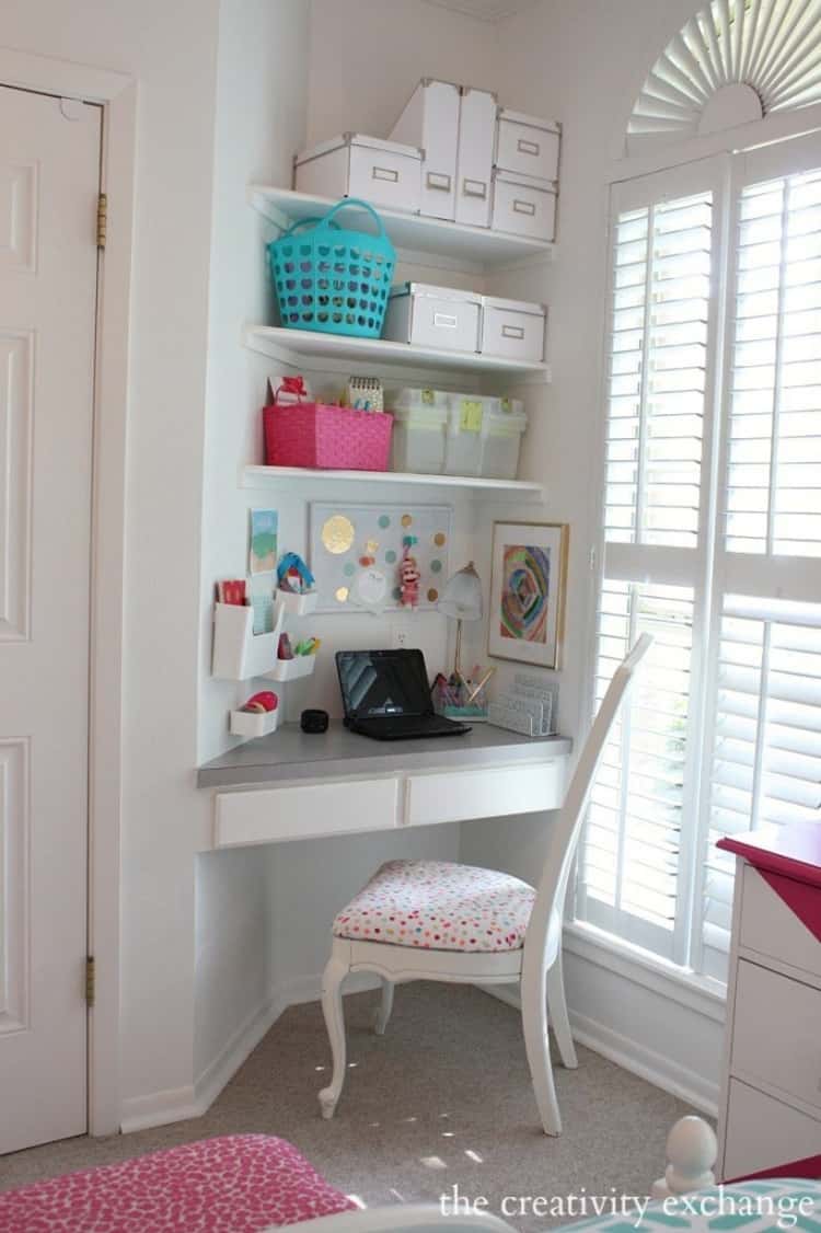 little girls desk built right into the corner with shelving above and a white chair too.