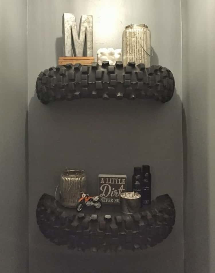 DIY shelving along a wall made from 2 halves of a motorcross tire