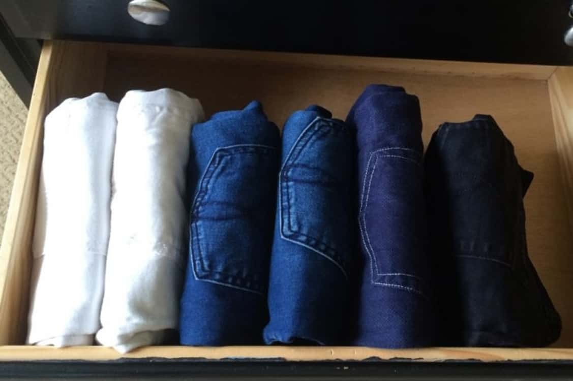 folded jeans filed away in drawer