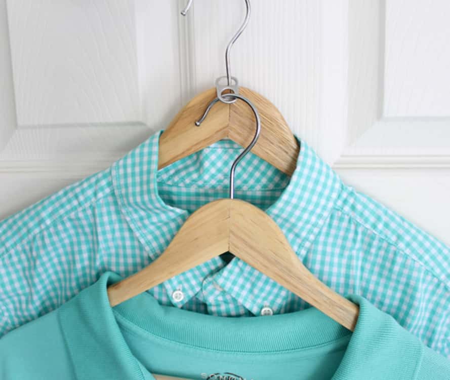 to store more clothes in less space, use a soda can tab to connect two hangers together