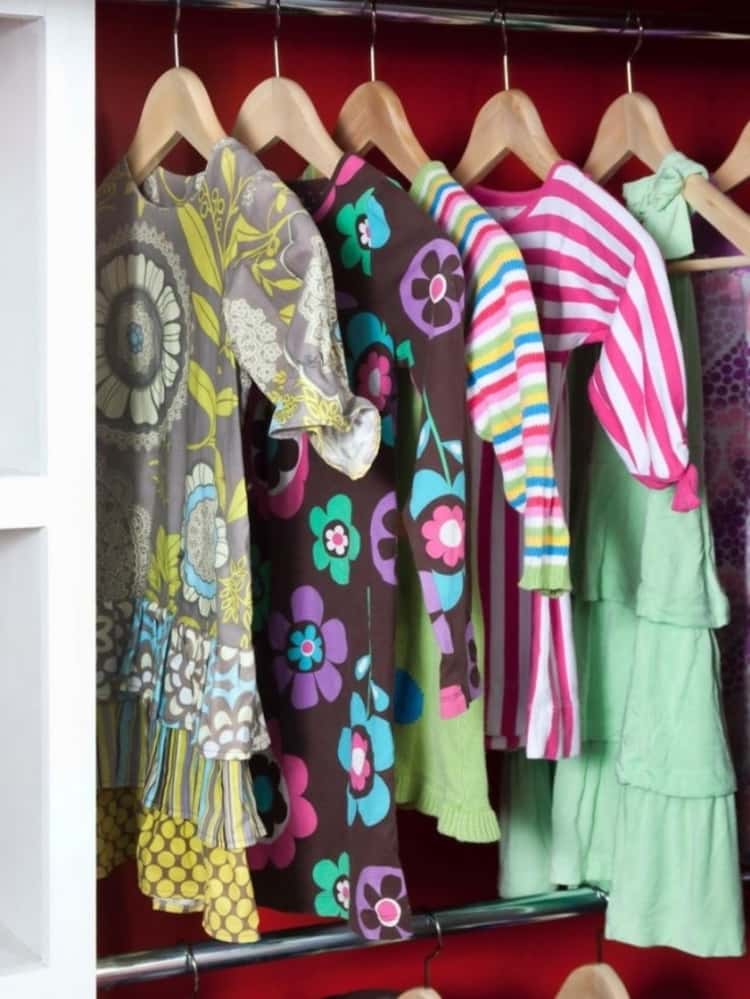 children's clothing hanging on closet rod