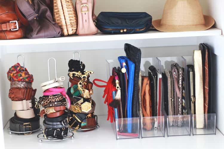 closet showing organized accessories including clutch bags in a clear magazine holder