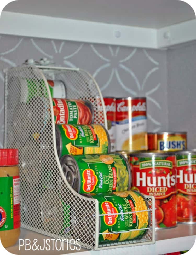 white magazine holder on it's side in a cabinet holding canned food