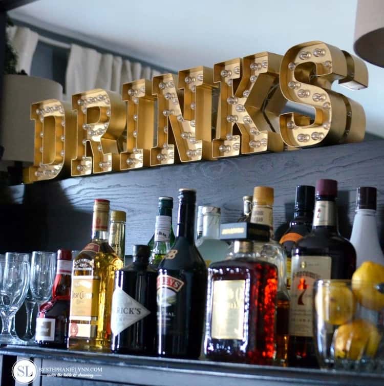 Letter marquee spelling the word DRINKS above the bar area