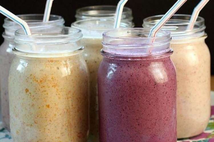 Several jars showing different colored oatmeal breakfast smoothies