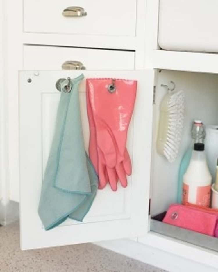 Put grommets in your cleaning gloves to hang them