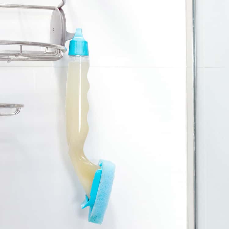 shower hacks - dish scrubber filled with dish soap and water hanging in the bathroom