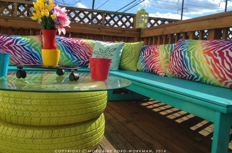 Deck ideas where you reuse old tires to paint and place as a table base for your new deck decor is pretty retro and cool. 