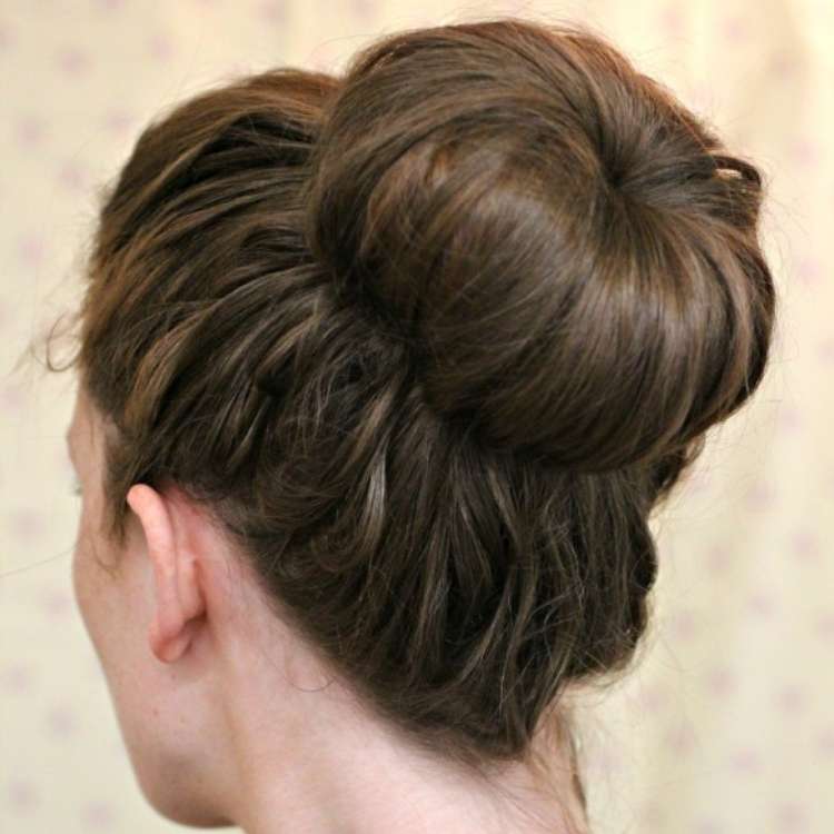 15 Easy Bun Hairstyles to Rock This Summer, brown haired woman wearing a textured sock bun