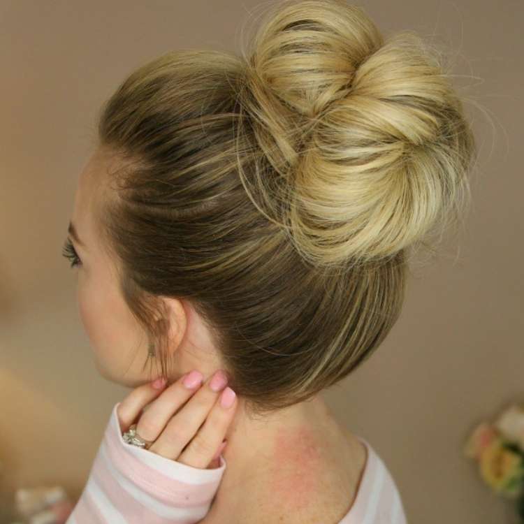 looped messy bun side view of a blonde woman with her hair in a rolled bun 
