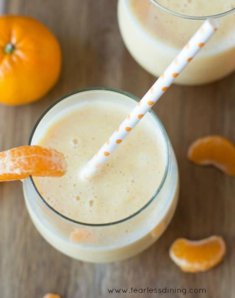 creamsicle smoothie, fresh orange slices , fresh orange smoothie with tall straw