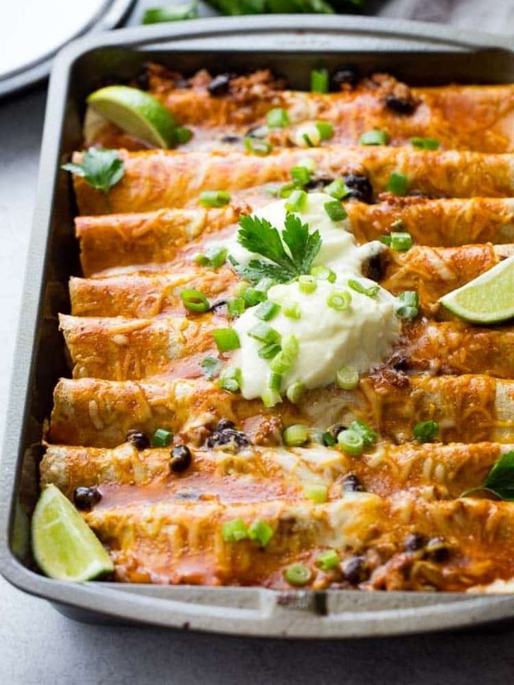 OneCrazyHouse ground turkey recipes bakeware filled with enchiladas topped with sour cream and lime slices