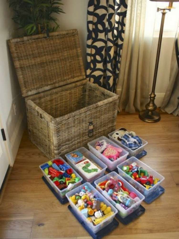 OneCrazyHouse kid friendly living room ideas Wicker chest with several trays of toys in front of it