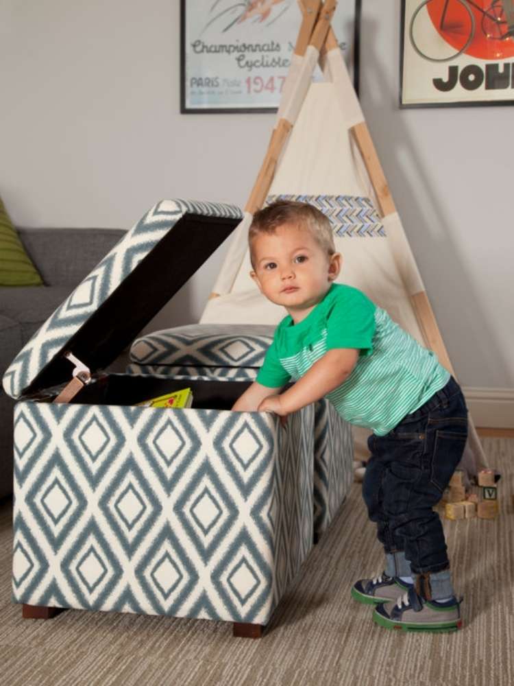 OneCrazyHouse kid friendly living room ideas child in front of mini teepee in living room reaching into a storage cube ottoman