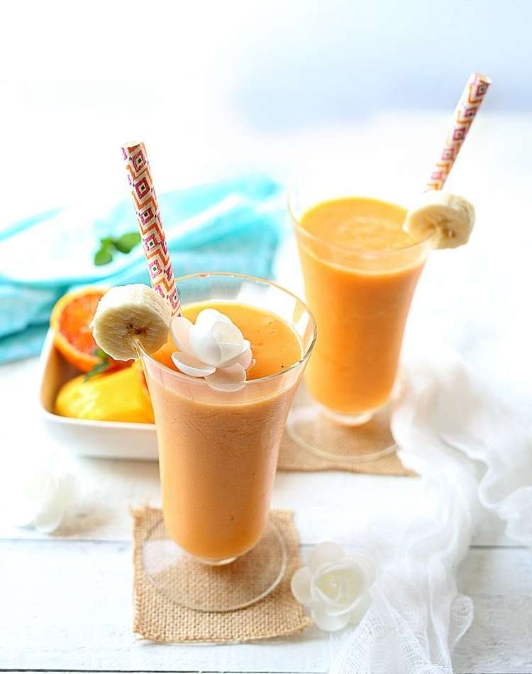 tropical smoothie, fresh fruit smoothie, fresh banana smoothie in tall glass with straw