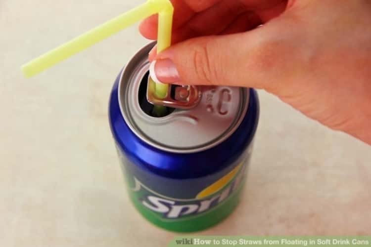 someone threading a straw through the soda can tab to keep the straw from popping up 