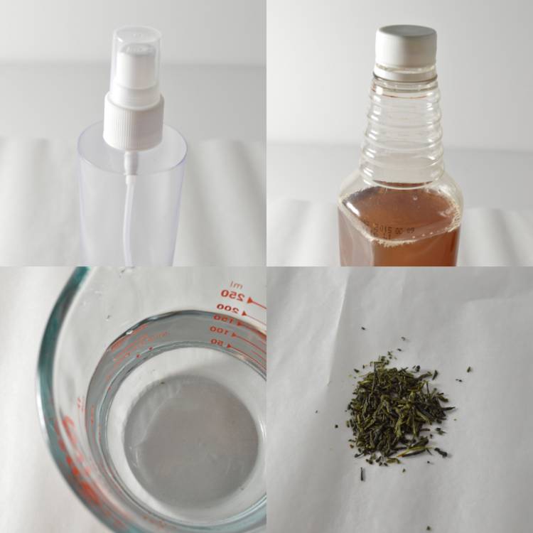 Image of ingredients for diy skin toner- a measuring cup with water, loose green tea leaves, a bottle of apple cider vinegar, and an empty spray bottle.
