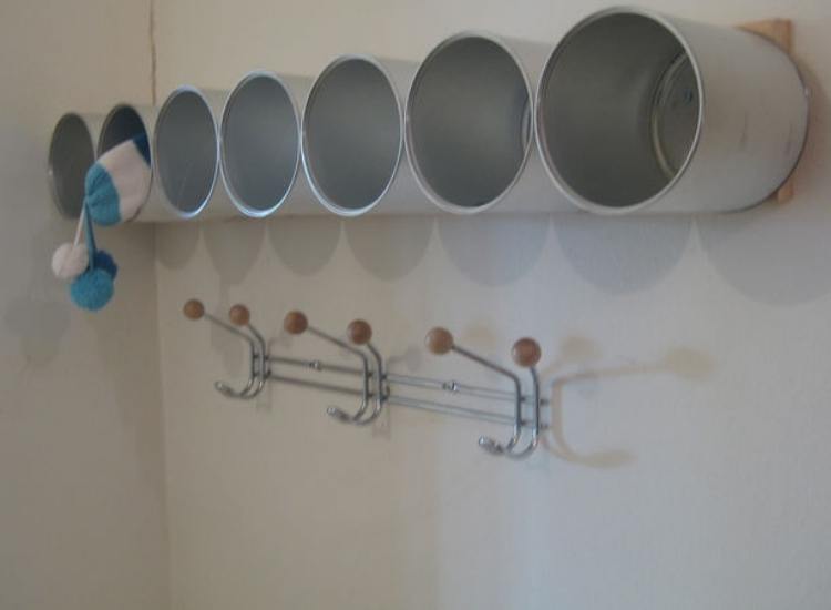 Repurpose formula canisters by installing them into the wall as cubbies.