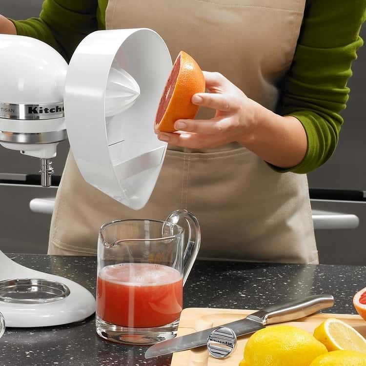 lady using the citrus juicer, an amazing Kitchen Aid mixer attachment to juice a grapefruit. 
