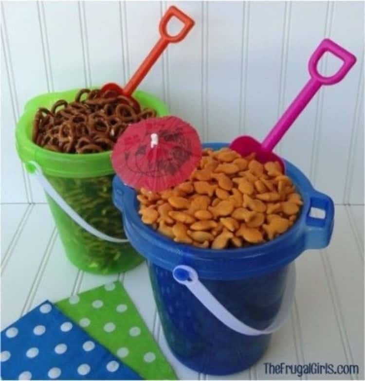 Cool summer party idea - snacks in beach pails with shovels to scoop them. Perfect for a beach-themed summer party